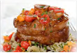 Braised Veal Shanks plated on a bed of vegetables and pasta